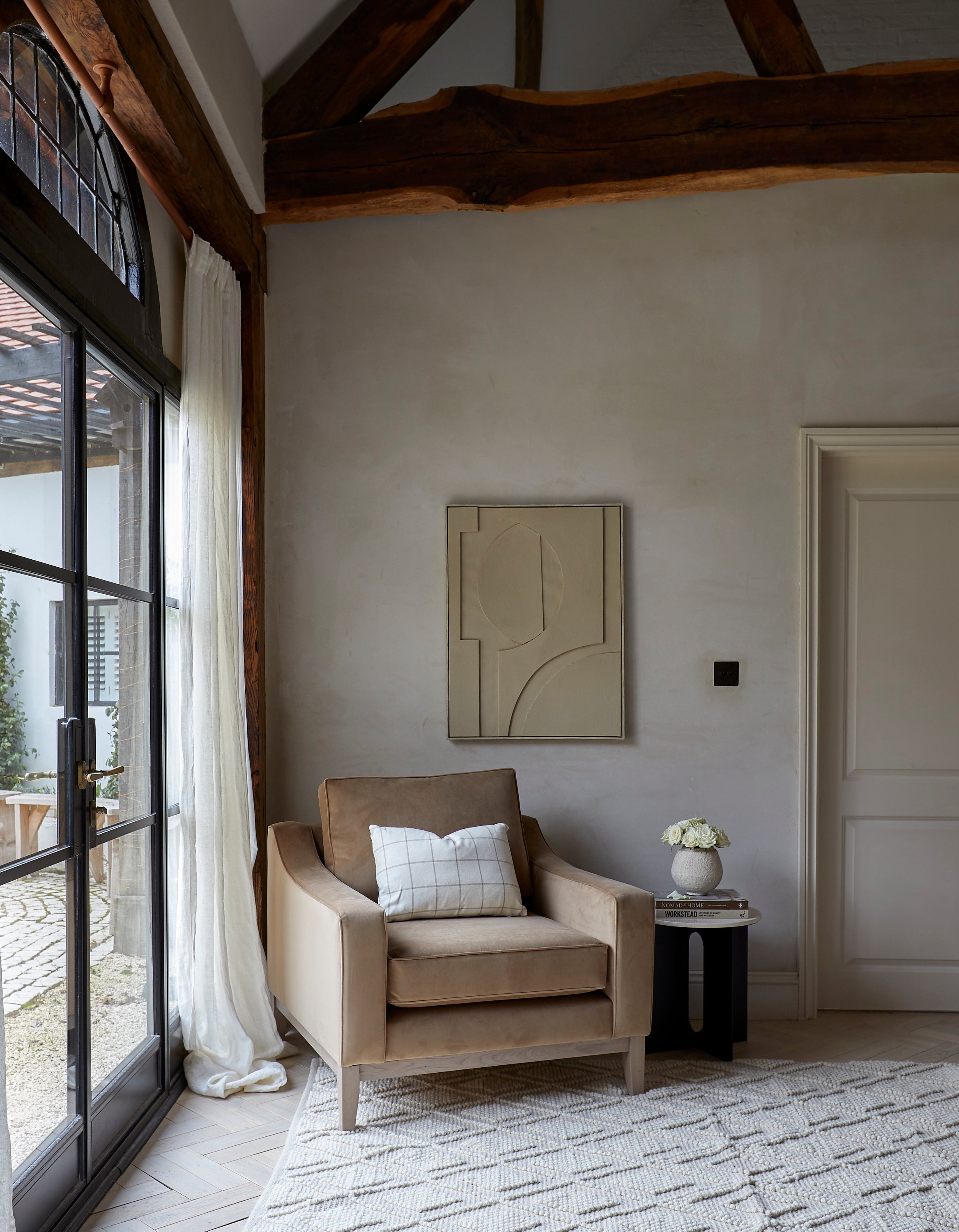brown velvet armchair cream rug taupe painting