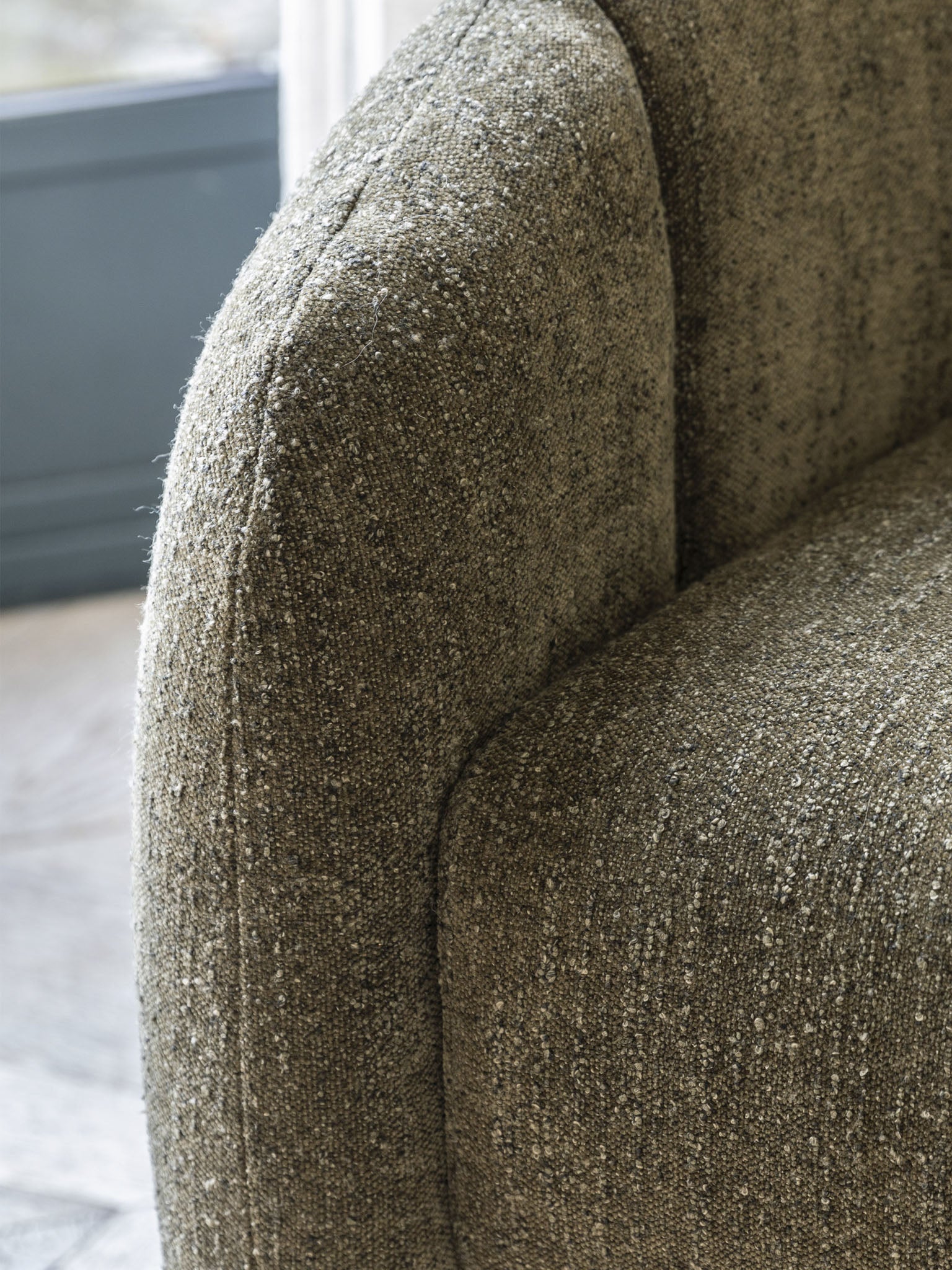Moss green tub chair with curved sides