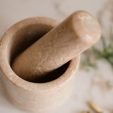 Mortar and pestle on a light surface with blurred background