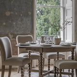 Round extendable dining table with bobbin detail