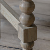 Round extendable dining table with bobbin detail