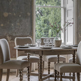 Round extendable dining table with bobbin detail