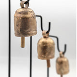 cow bells on a black metal stand set of 3