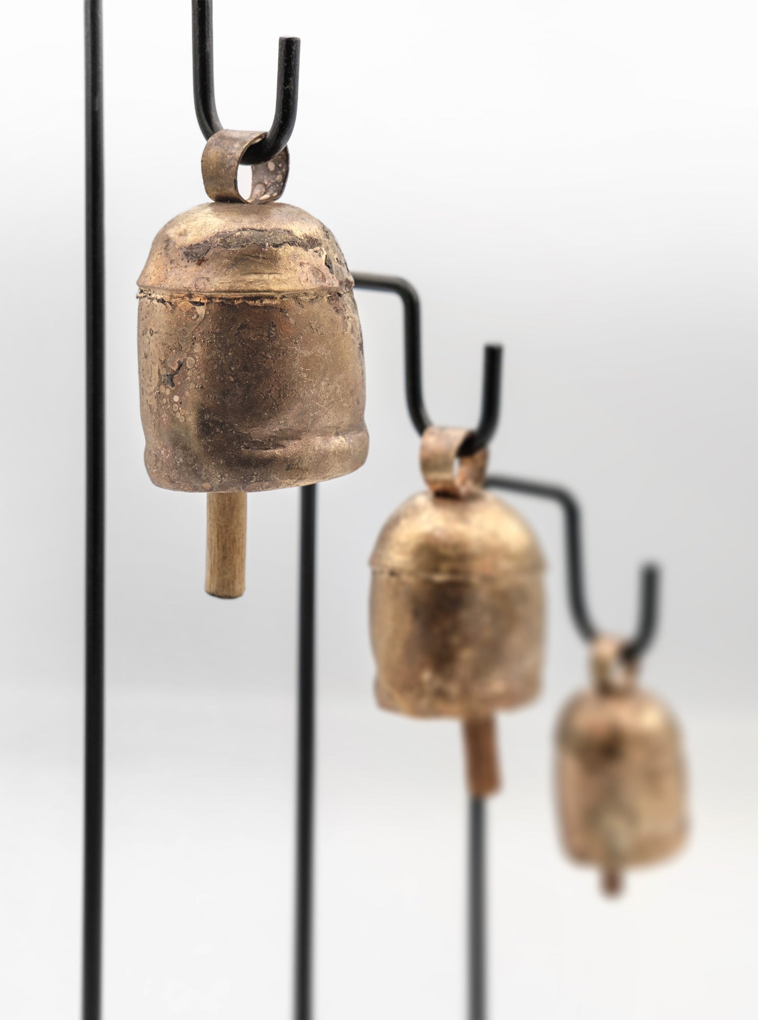 cow bells on a black metal stand set of 3