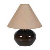 Table lamp with a brown glass base and beige fabric shade on a white background