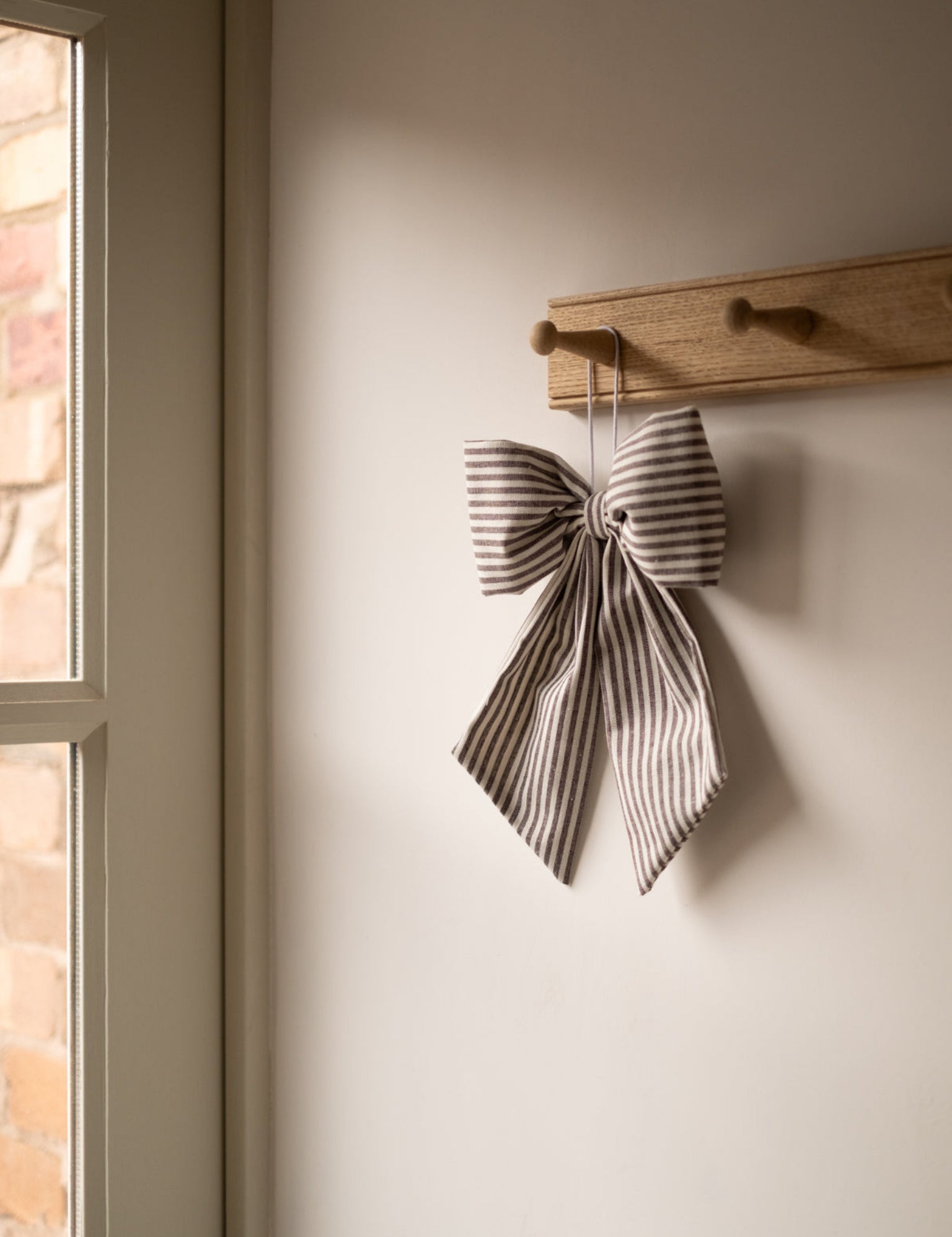 Black and White Stripe Hanging Bow, hanging from a rack