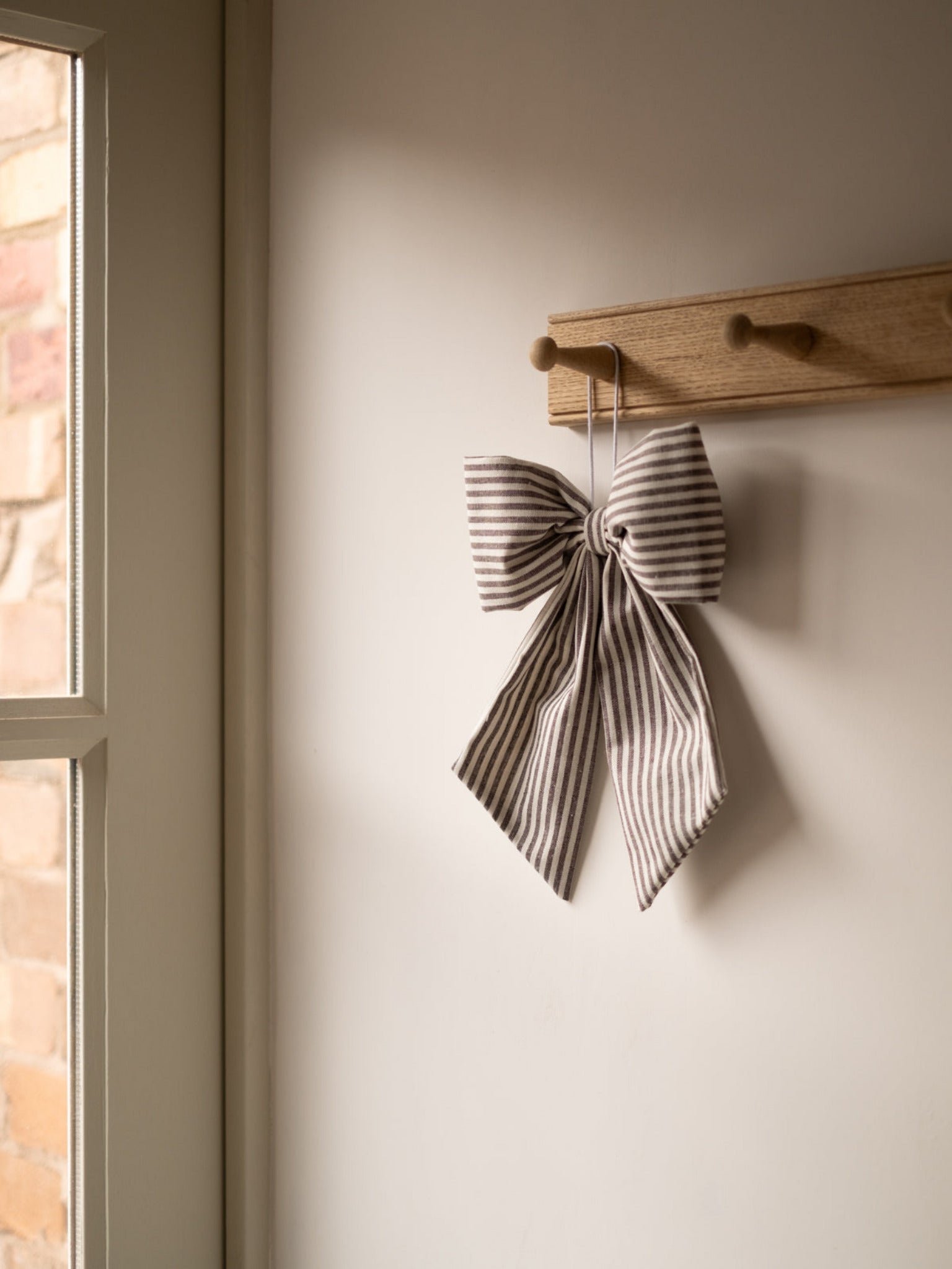 Black and White Stripe Hanging Bow, hanging from a rack
