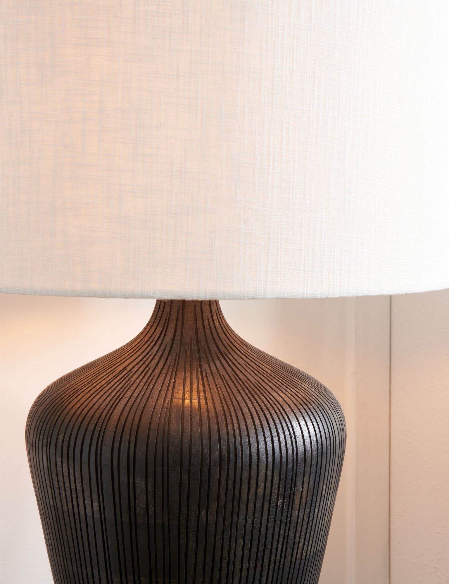 Antique black textured wooden table lamp.