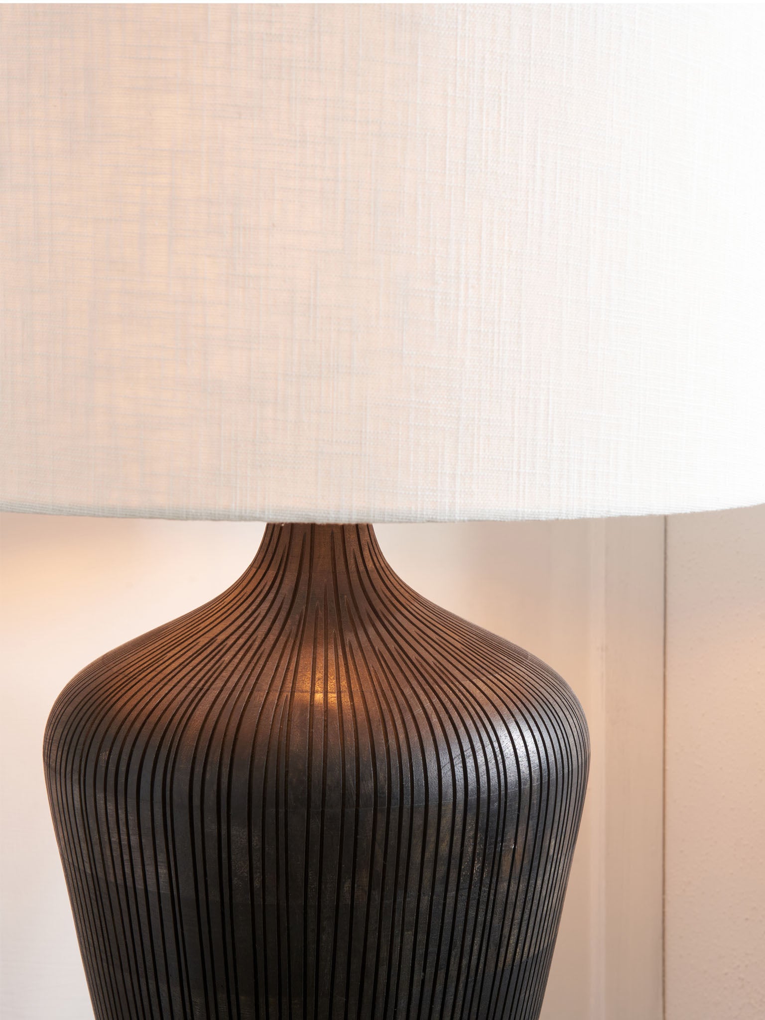 Antique black textured wooden table lamp.