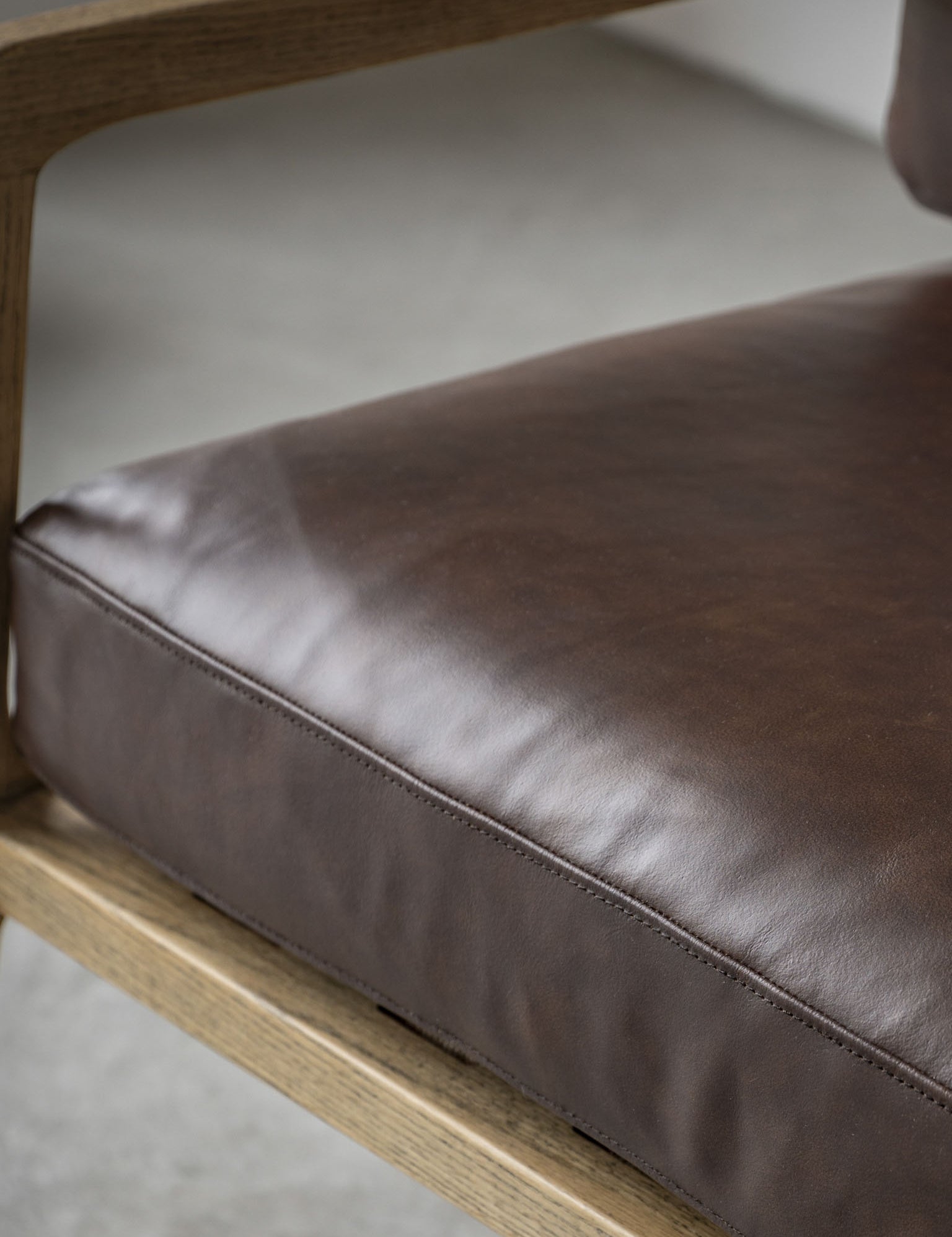 Brown armchair in Antique Brown Leather with wooden arms