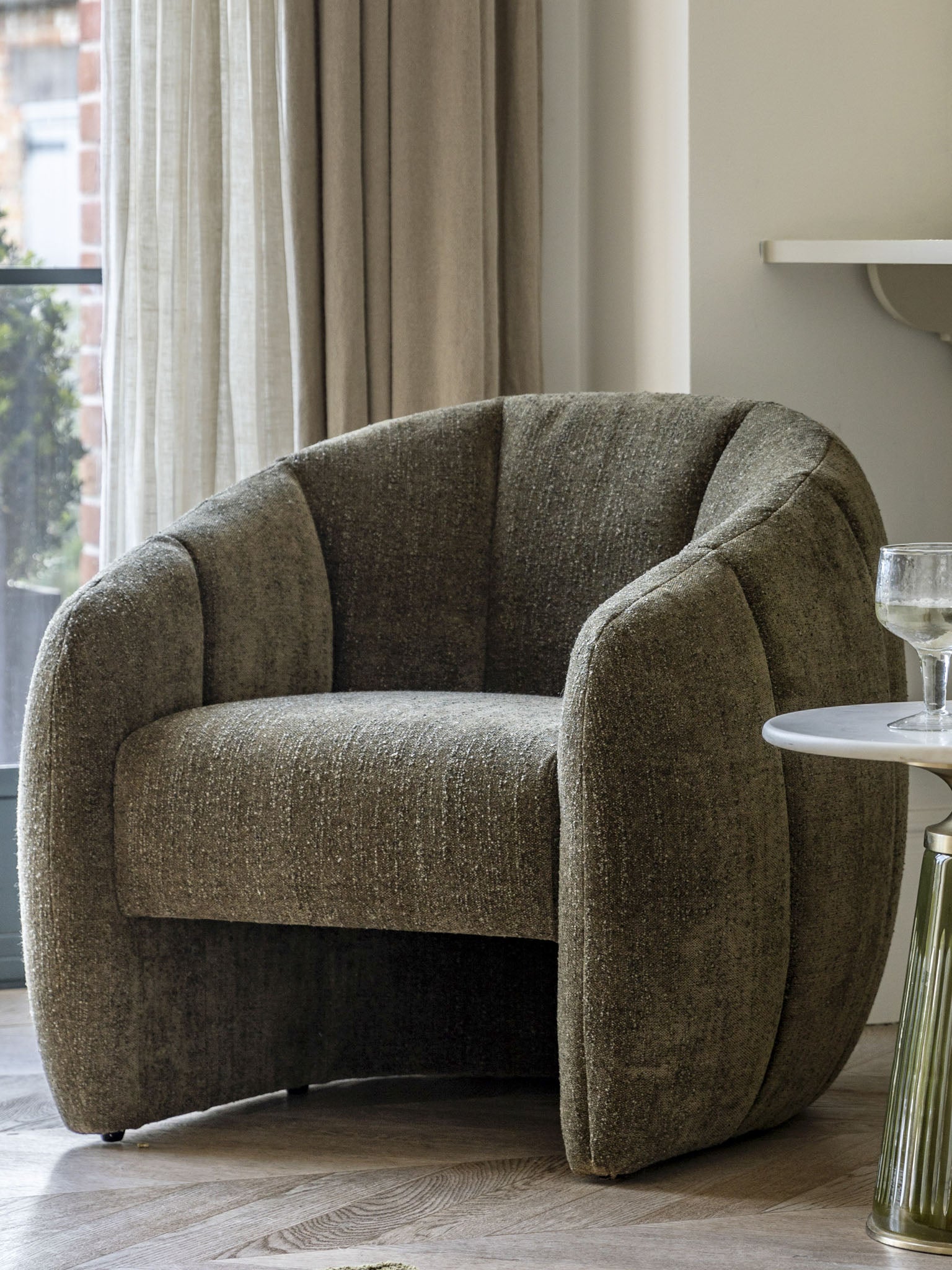 Moss green tub chair with curved sides