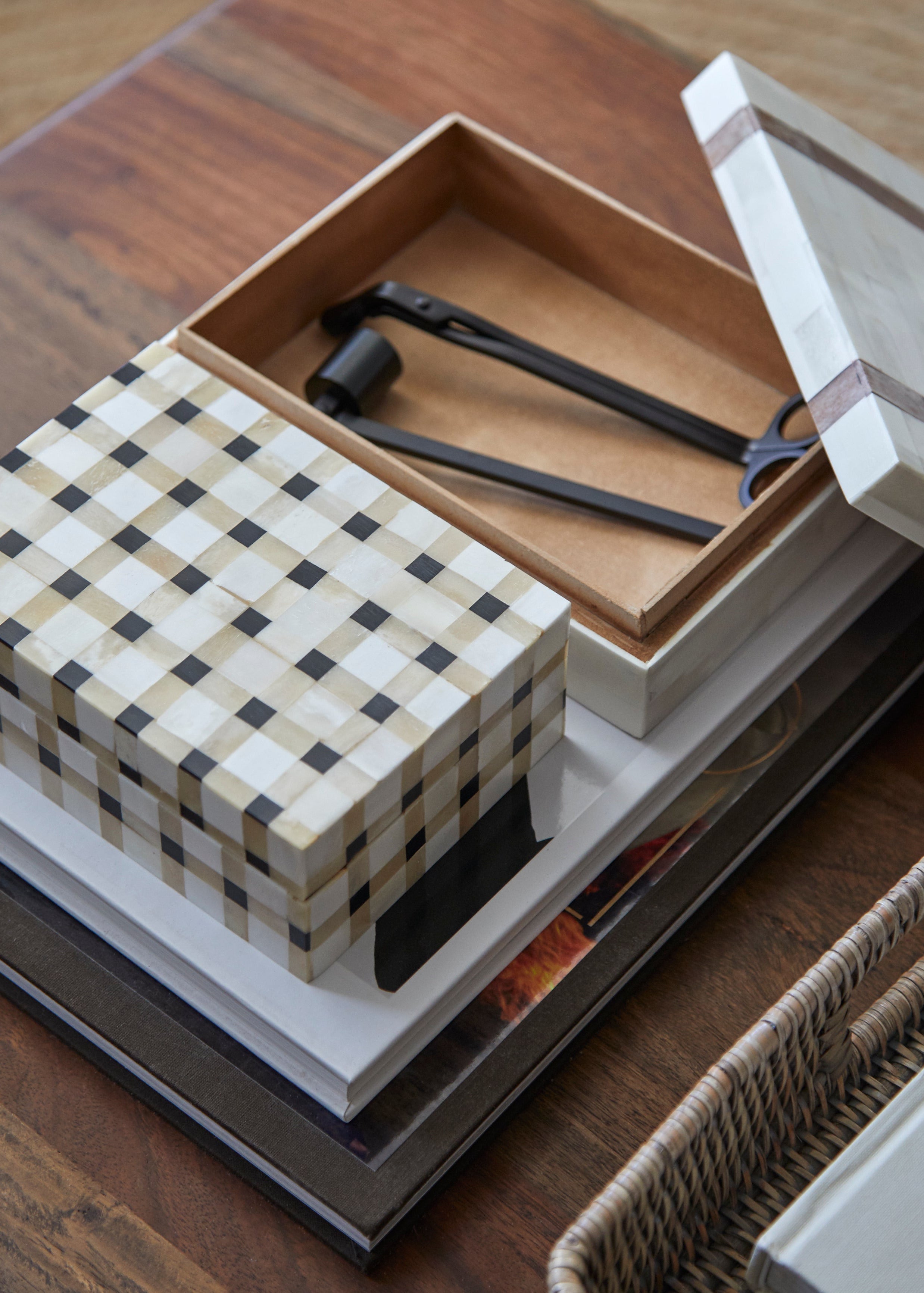 Checkered box with tools inside on a wooden surface