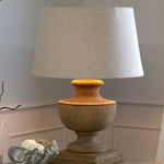 wooden turned lamp with pale linen shade