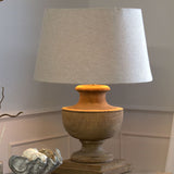 wooden turned lamp with pale linen shade