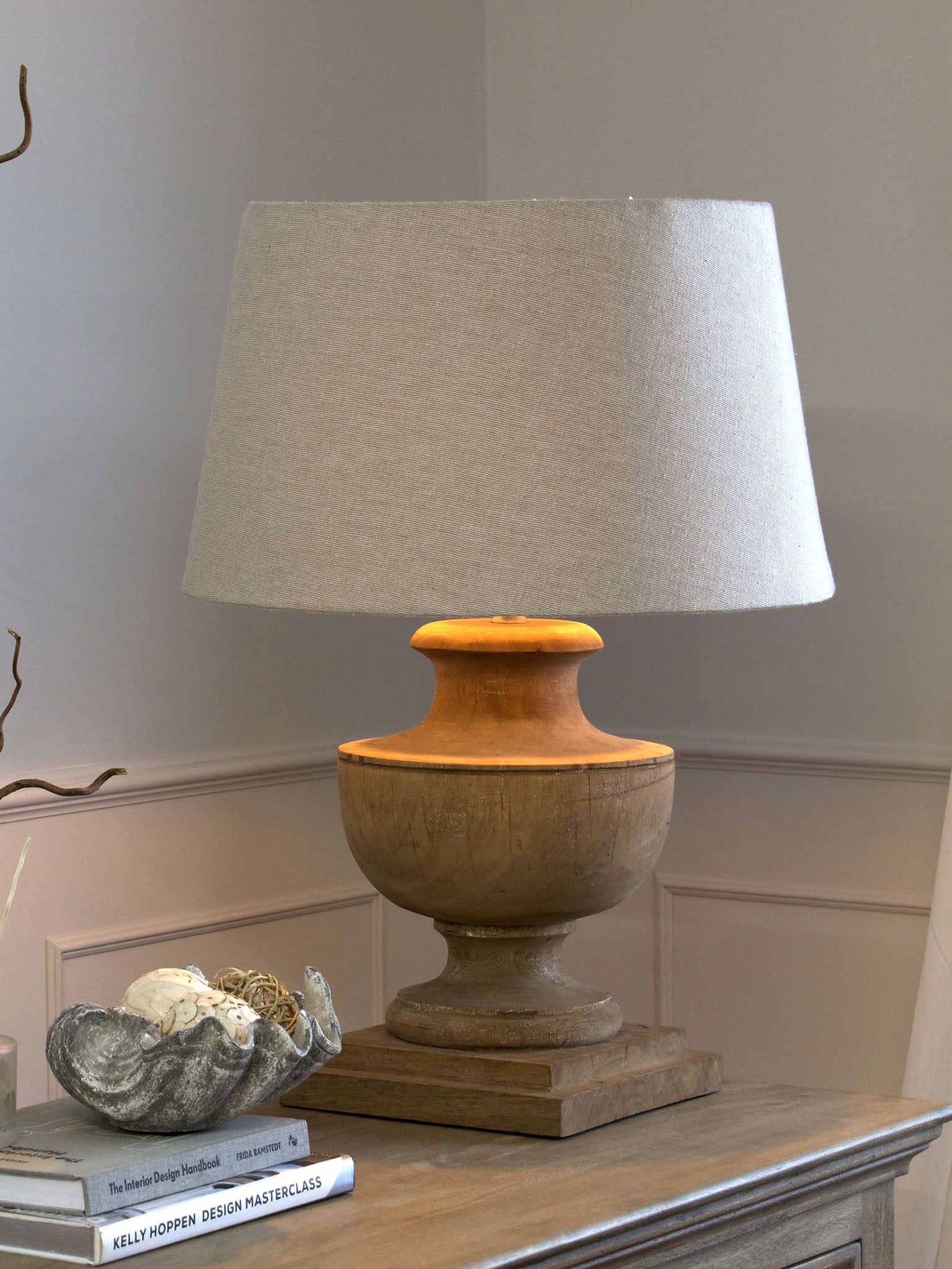 wooden turned lamp with pale linen shade