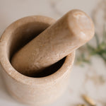 Mortar and pestle on a light surface with blurred background