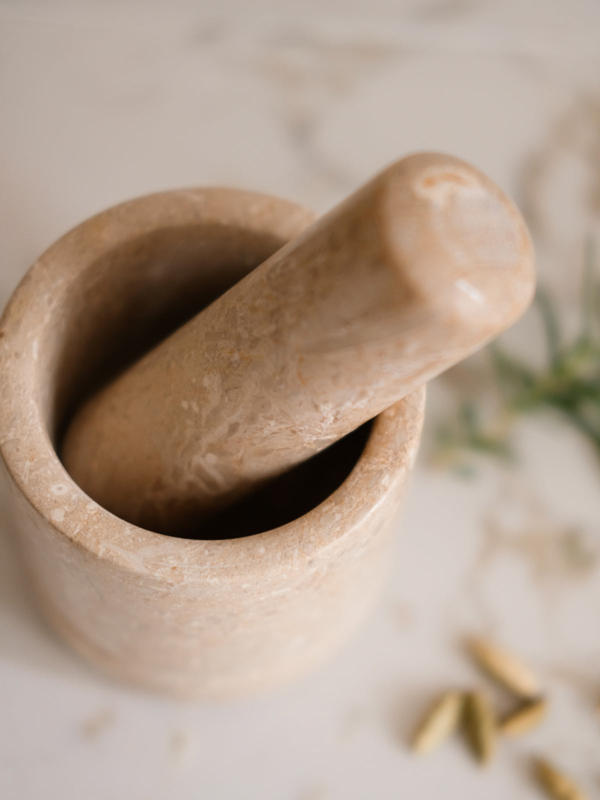 Mortar and pestle on a light surface with blurred background
