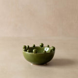 Green ceramic bowl with small green balls