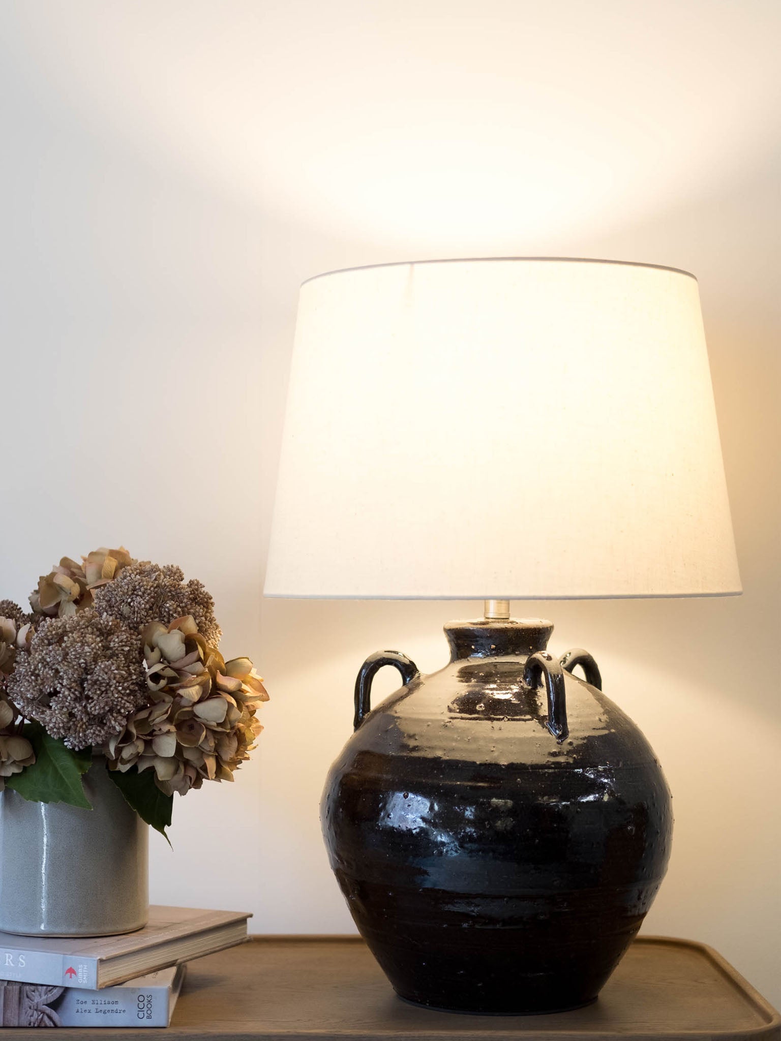 black ceramic urn table lamp with white taper shade