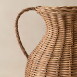 Close-up of a wicker pitcher on a neutral background