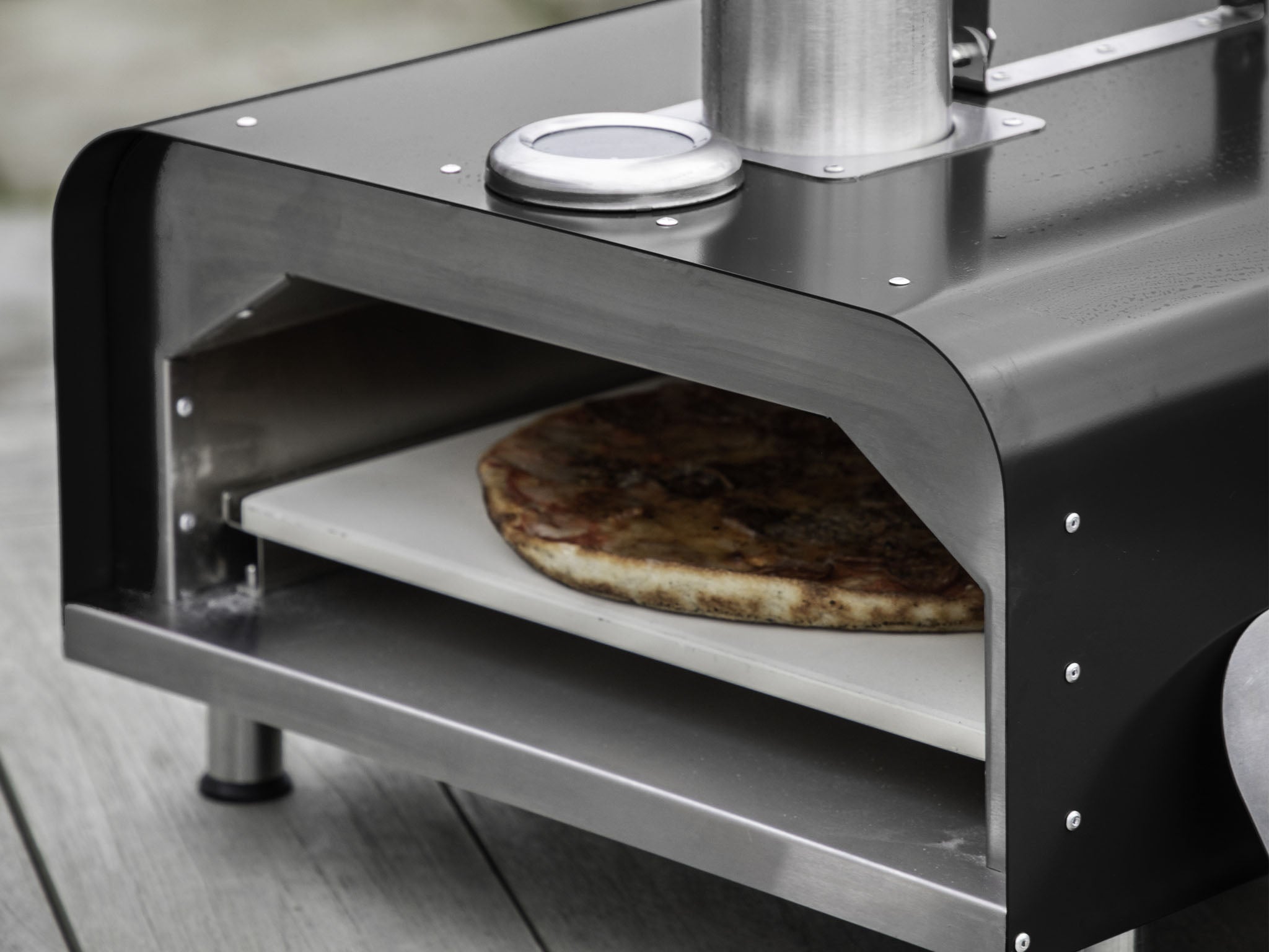 pellet fed stainless steel and black pizza oven